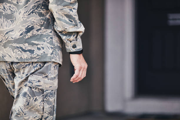 istock Military service member wearing fitness tracker arriving home from work 954069864