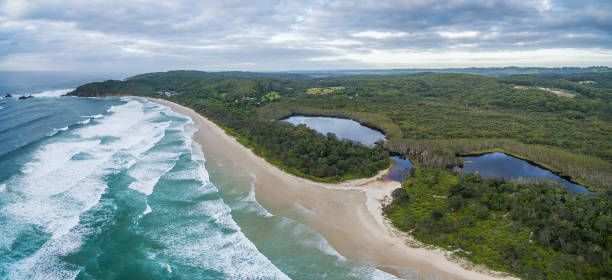 istock Ocean coastline under moody sky - aerial view 954070188