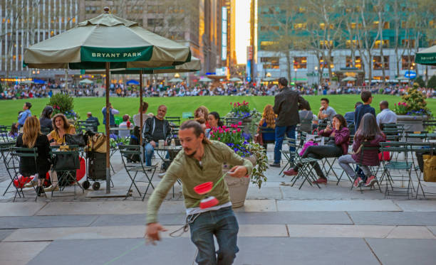 A Juggler Practicing Diabolo at Bryant Park Terrace At Sunset stock photo