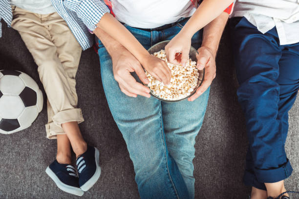 istock family eating popcorn 954077930