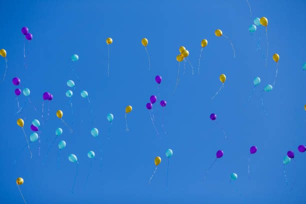 istock Group of floating multicolored balloons in the blue sky 954084646