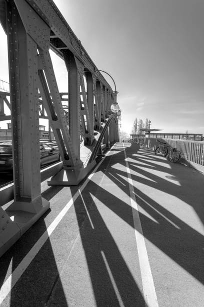 Shadows through the pillars of a bridge, on a sunny spring afternoon. Infrared black and white version.