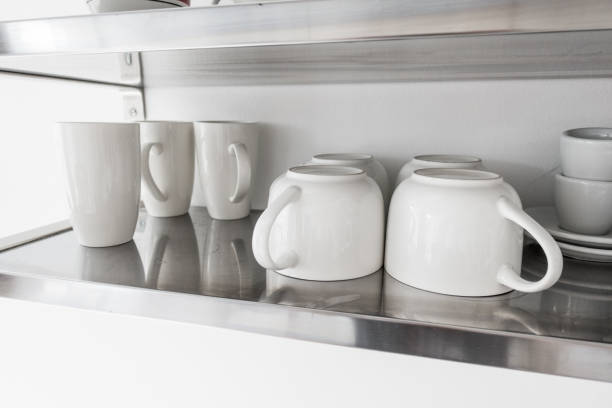 istock Ceramic bowls and mugs on shelf 954088296