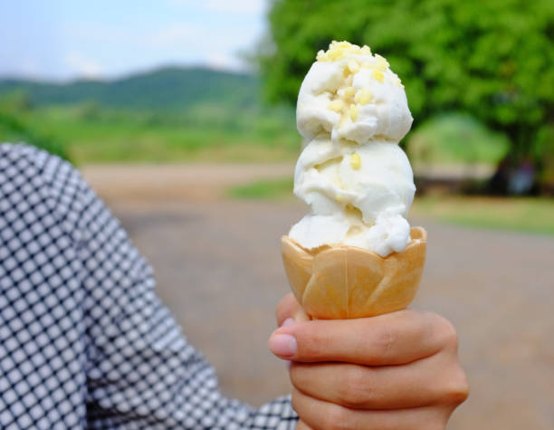 istock Close-up hand holding ice-cream. 954089742