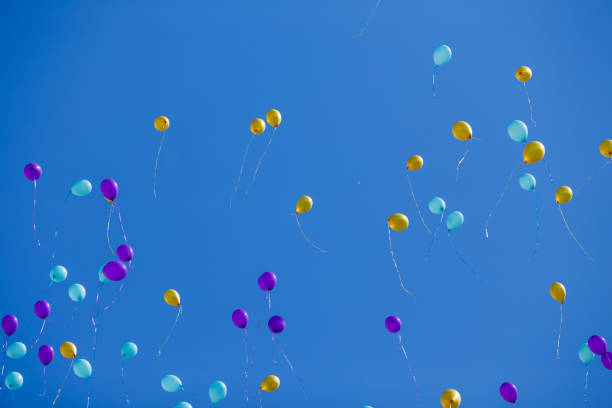 istock Group of floating multicolored balloons in the blue sky 954094312