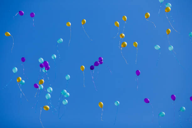 istock Group of floating multicolored balloons in the blue sky 954094388