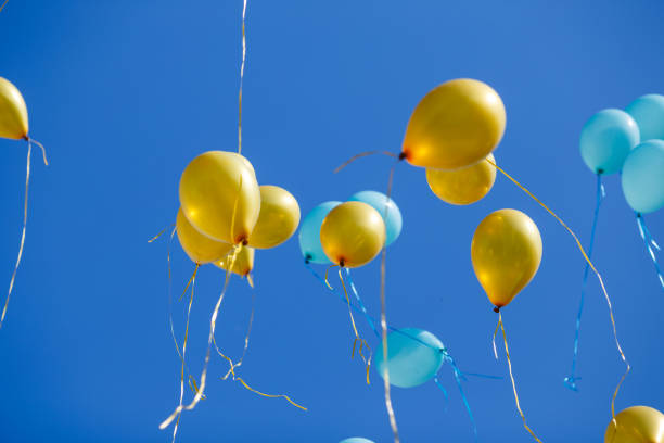 istock Floating balloons in the blue sky 954094828