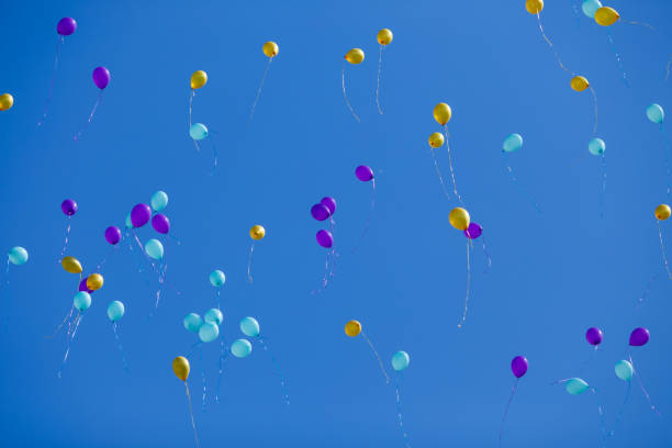 istock Group of floating balloons in the blue sky 954094890