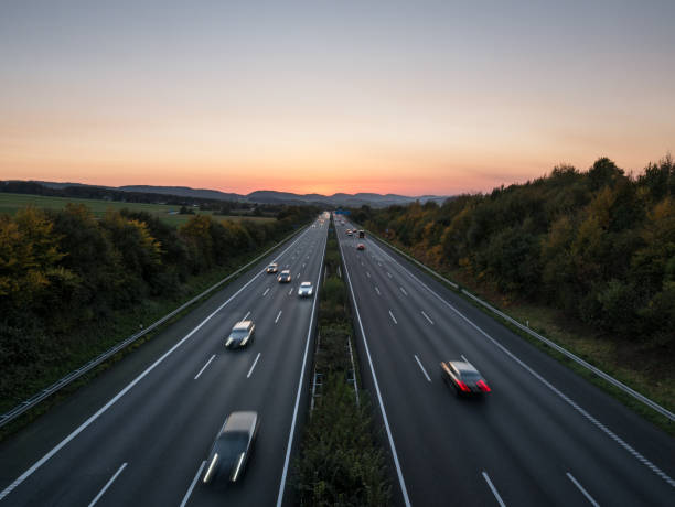 istock The road traffic on a motorway at sunset 954095002