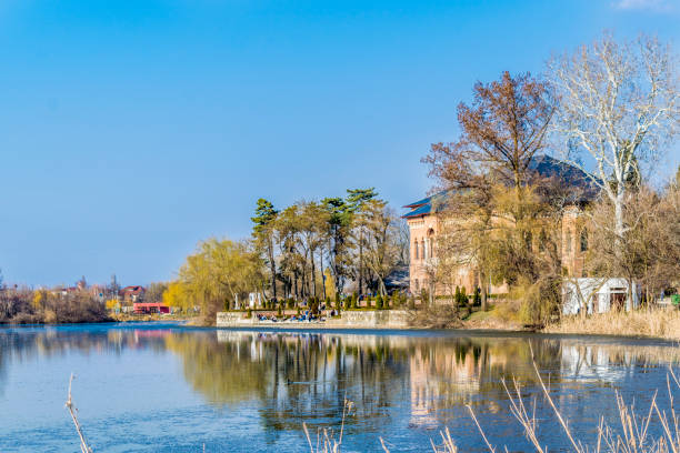 istock Lake and trees with blue sky 954098714