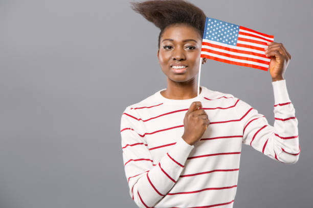 istock Delighted nice woman showing American flag 954101630