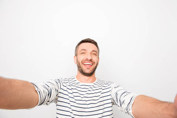 istock Handsome smiling happy man making selfie on white background 954102486