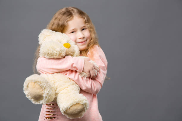 istock Delighted nice girl hugging her toy 954103336