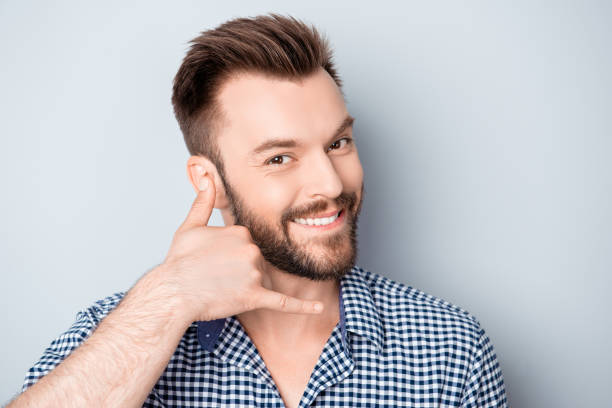 istock Portrait of cheerful smiling guy asking to call him 954103674