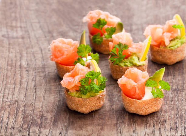 croustades  crispy pastry cases filled with salted salmon and avocado on wooden table - vol au vent imagens e fotografias de stock