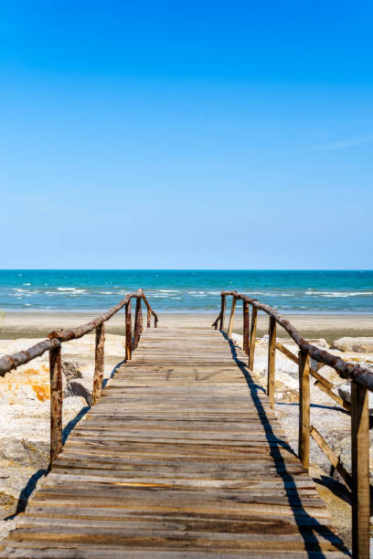 istock Wooden bridge walkway to the sea beach 954108402