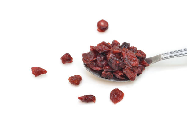 istock Dried cranberries in a spoon on white background 954110978