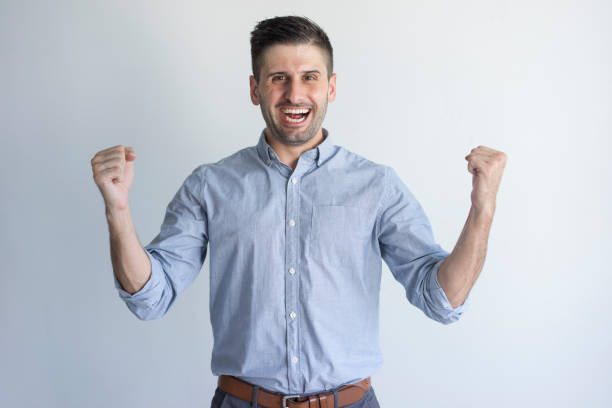 istock Cheerful jolly handsome young man excited about success 954111508