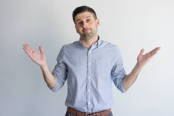 istock Misunderstanding handsome young businessman shrugging shoulders 954111604
