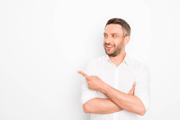 istock Handsome bearded businessman gesturing with finger showing direction 954112162