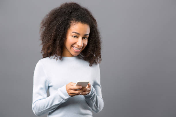 istock Joyful positive woman holding her smartphone 954112308