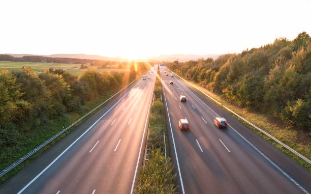 istock The road traffic on a motorway at sunset 954117174