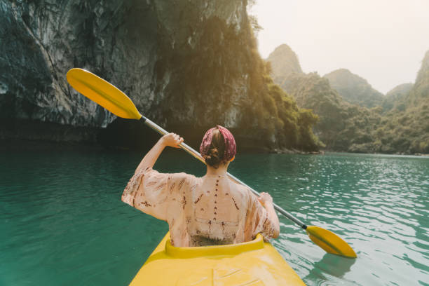 Woman kayaking in Halong Bay Young Caucasian woman  kayaking in Halong Bay gulf of tonkin photos stock pictures, royalty-free photos & images