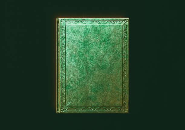 istock mock up book brown green color on black background close-up, top view 954125190