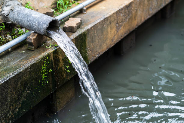 istock Wastewater flow to sewer, Sewer pipes to small canal 954129476