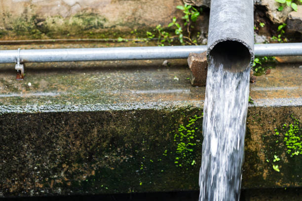 istock Wastewater flow to sewer, Sewer pipes to small canal 954129488