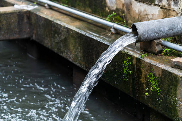 istock Wastewater flow to sewer, Sewer pipes to small canal 954129538