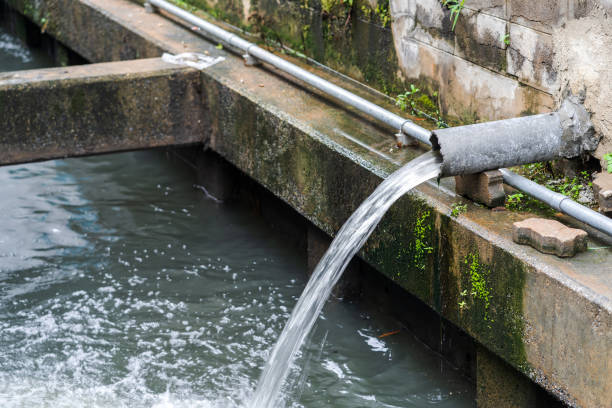 istock Wastewater flow to sewer, Sewer pipes to small canal 954129572
