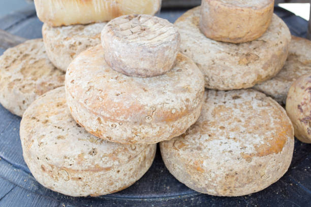 istock rustic french cheese wheels stacked on the marketplace 954131064