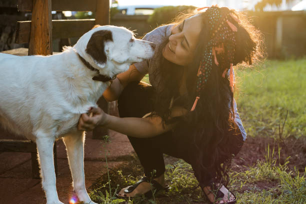 istock Smiling Young Woman Embracing a Dog 954134796