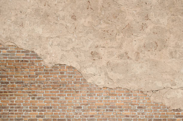 istock Vintage textured old brick wall with stained and shabby uneven plaster background 954134952