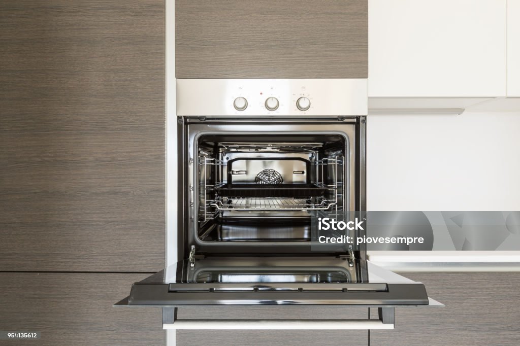 Detail of open kitchen oven Detail of open kitchen oven. Copy space Oven Stock Photo