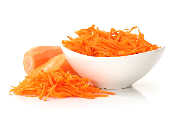 istock Pile of grated carrots and grater on white background 954136002