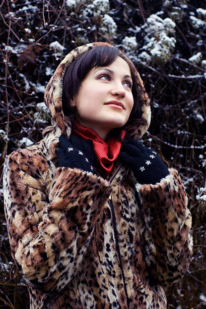 istock Young woman in leopard fur coat looking up 95414053