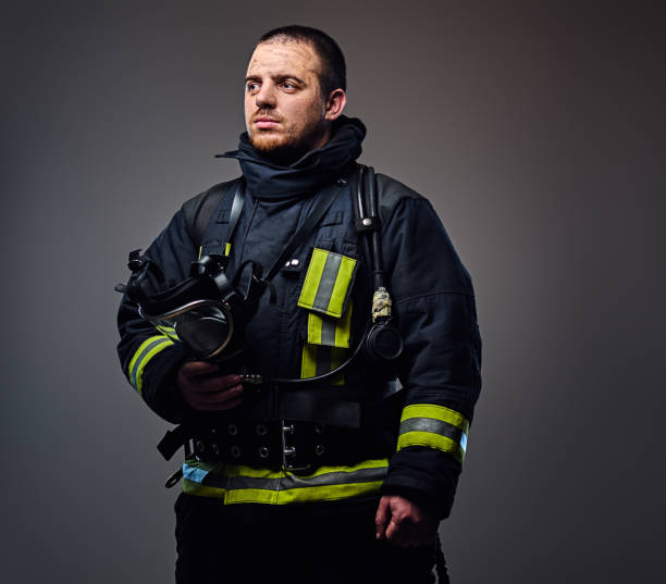istock Studio portrait of a male dressed in a firefighter uniform. 954141754