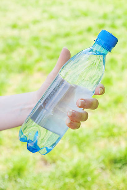 istock hand with bottle of water 95414197