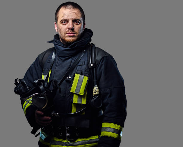 istock Studio portrait of a male dressed in a firefighter uniform. 954142156