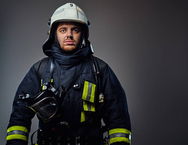 istock Studio portrait of firefighter dressed in uniform. 954142364