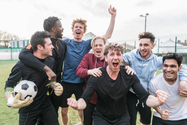 istock Team cheering football match success 954142700