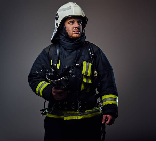 istock Studio portrait of firefighter dressed in uniform. 954145702