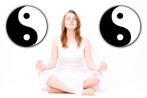 a woman meditating between yin and yand symbolshttp://gallery.photo.net/photo/12551826-lg.jpg