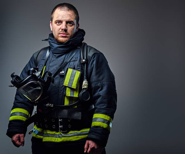 istock Studio portrait of a male dressed in a firefighter uniform. 954148844