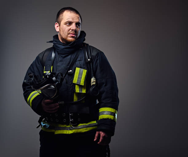 istock Studio portrait of a male dressed in a firefighter uniform. 954149404