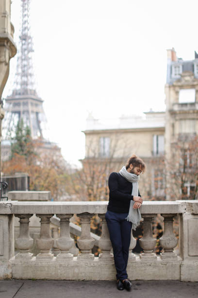 istock Afro american man standing near concrete railing with Eiffel Tower background in Paris 954149760