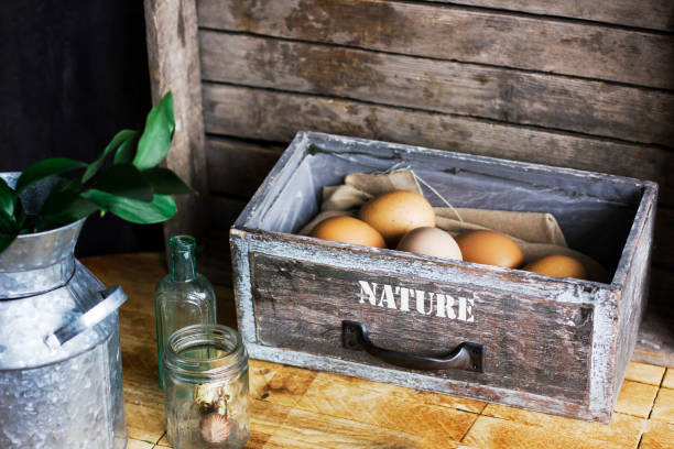 Brown chicken eggs in old wooden box, home farm