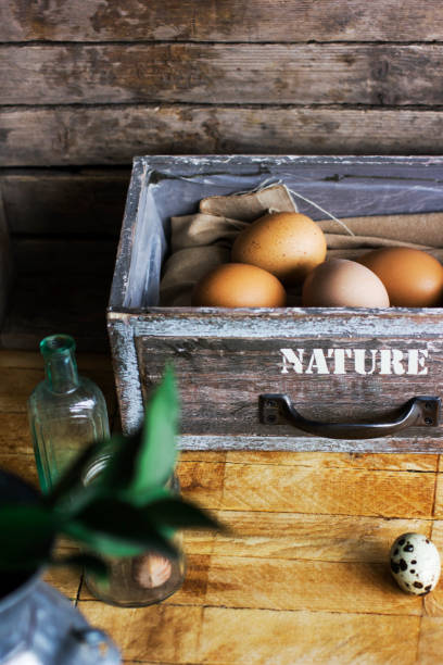 istock Brown chicken eggs in old wooden box, home farm 954151136